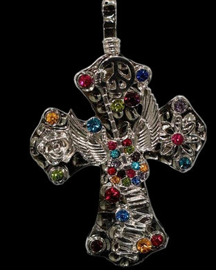A multicolored rhinestone cross pendant with a winged guitar design and a magnetic closure.